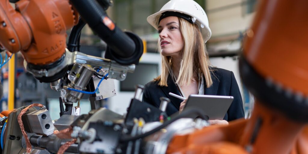 Engineer reviewing industrial machinery for CE/UKCA compliance and operational safety