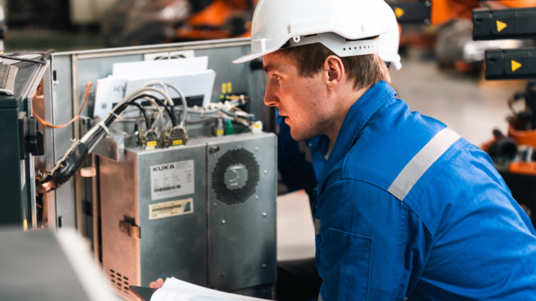 Engineer inspecting electrical equipment inside a machine control panel for EN 60204-1 verification
